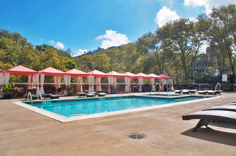 An overall photo of the Metroclub condoiminium building's pool area.